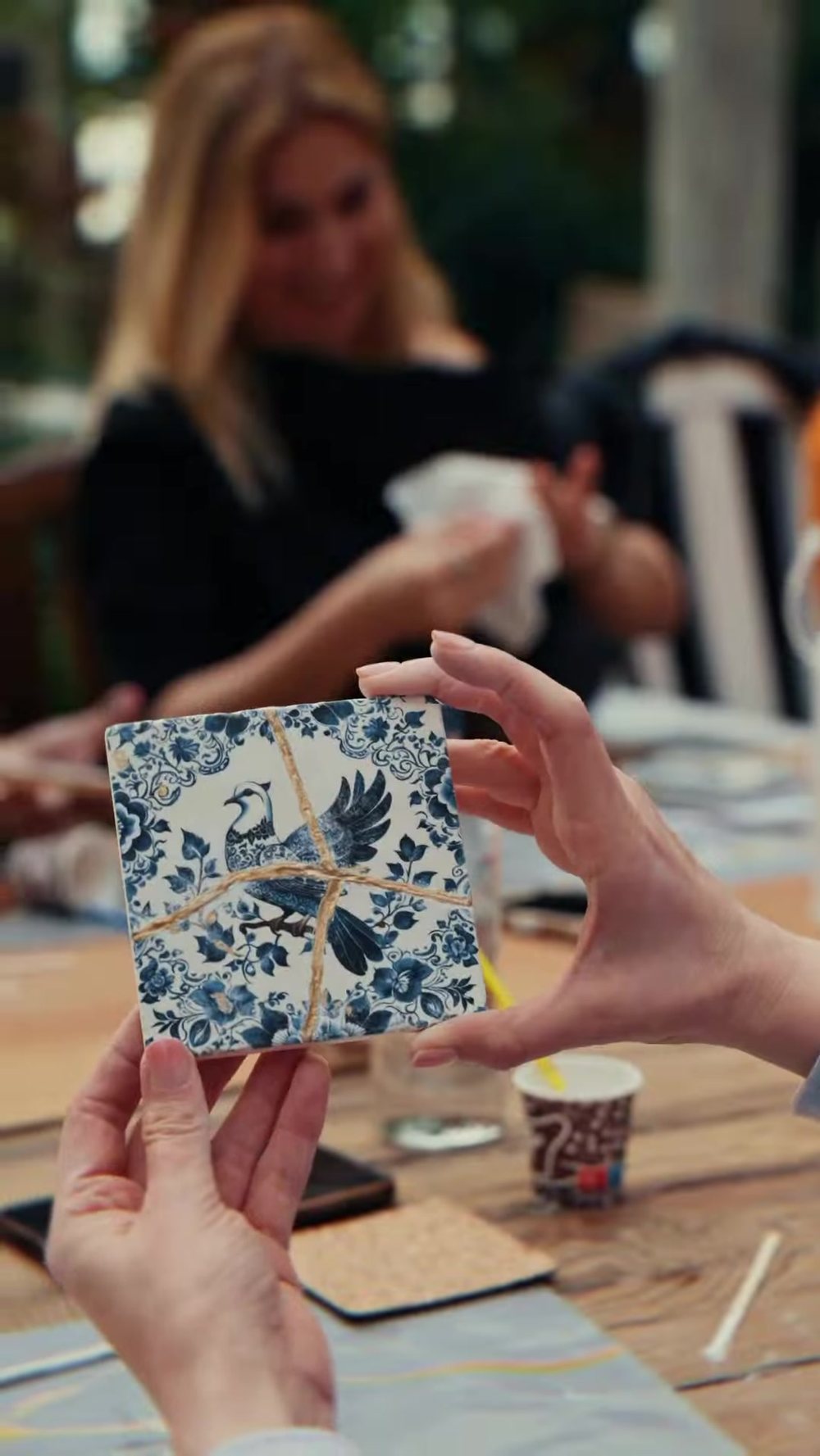 A tile mended with gold during the Kintsugi atelier